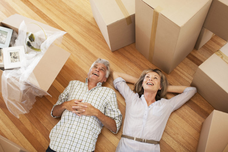 couple laying on floor of new house