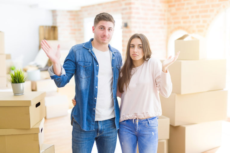 young couple moving to a new house confused